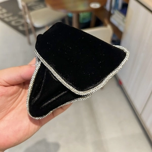 Close-up of velvet hair claw with silver rhinestone trim and geometric triangle shape