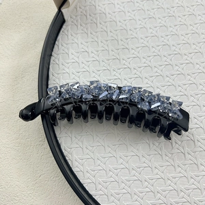 Elegant black banana clip with light blue crystals for thick hair styling