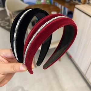 Detail of burgundy and black velvet headbands with sparkling rhinestone embellishment