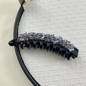Large black banana hair clip with purple crystal embellishments for ponytails