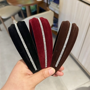 Detail of velvet headbands set with dual rows of rhinestones in burgundy, black and coffee