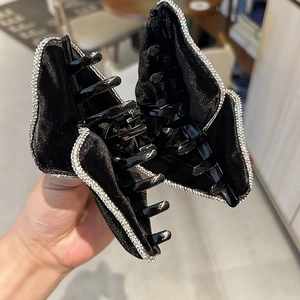Detail of black velvet hair claw clip with sparkling rhinestones and sturdy inner teeth