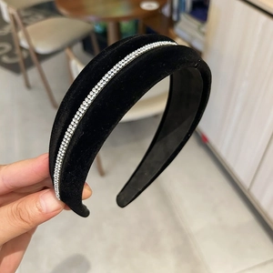 Elegant wide black velvet headband with a row of sparkling white rhinestones