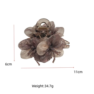 Detail view of champagne organza flower hair claw clip with beads measuring 11cm