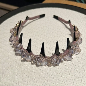 Detailed macro view of the lavender crystal beads and black punk spikes on the headband
