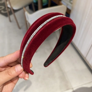 Close-up of vintage burgundy velvet headband with sparkly white rhinestone inlay