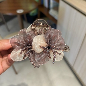 Elegant organza flower hair claw clip with crystal accents in pink and champagne colors
