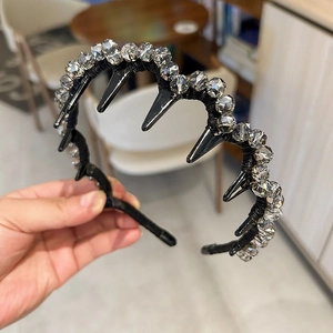 Detail of Korean luxury headband showing clear crystals and black wave tooth comb design