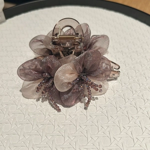 Detail view of large organza flower hair claw clip with shimmering petals and beads