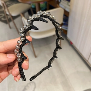 Detail of black crystal headband showing clear rhinestones and non-slip hair comb teeth