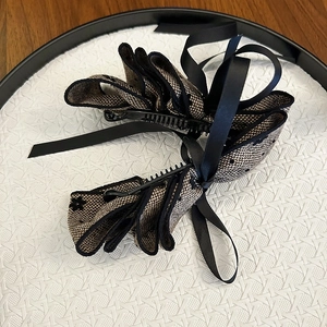 Elegant multi-layer bow banana hair clip with beige and black checkered ribbon pattern