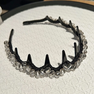 Close-up of black crystal headband with smoky grey beads and gothic spikes detail