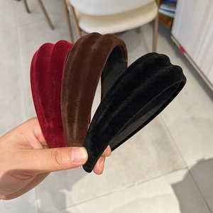 Detailed macro view of vintage padded velvet headbands in red, brown, and black colors