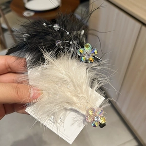 Detail of fairy feather hair clips with crystal beads and elegant pearl accents