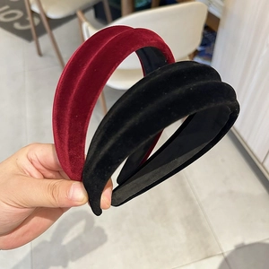 Detailed view of burgundy and black velvet padded headbands with soft fabric texture