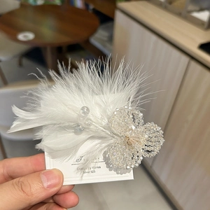 Elegant white feather hair clip with crystal flower beads and silver finish details