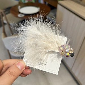 Elegant white feather hair clip featuring iridescent crystal flowers in Korean style