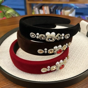 Detail of velvet headbands set with pearls and crystals in black, brown and wine red