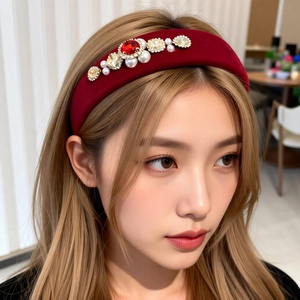 Close-up of wine red velvet headband with pearls and rhinestones on hair model
