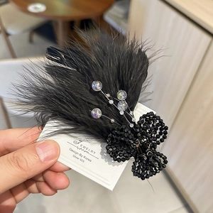 Elegant black feather hair clip with crystal beads and pearls on display card