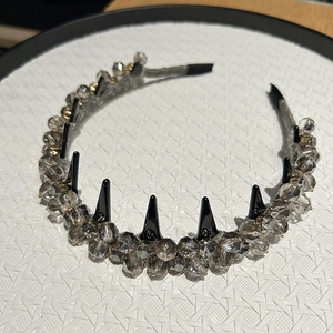 Detail of luxury rhinestone headband with black spikes and faceted crystal beads