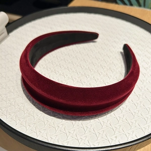 Close-up of vintage burgundy velvet headband with thick sponge and soft texture