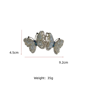 Detail view of crystal butterfly hair clip with blue stones and silver finish 4.5x9.2cm