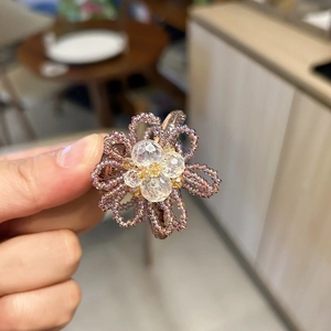 Detail of handmade purple crystal flower hair claw with intricate beaded texture