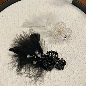 Detailed macro of crystal beads and soft faux feathers on elegant hair clips set