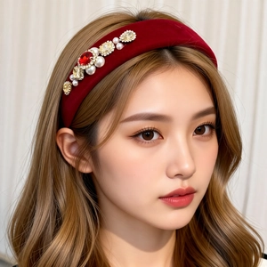 Close-up of wine red velvet headband with pearls and square diamond embellishments
