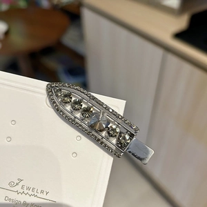 Elegant silver metal hair clip with dark grey rhinestones and transparent zircon stones