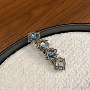 Elegant vintage spring hair clip with blue and champagne crystals in a retro metal frame