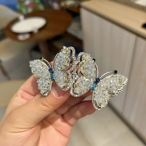 Detail showing crystal butterfly hair clip with blue and clear rhinestones