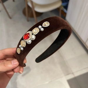 Detail of vintage velvet headband with red crystals and pearls on thick padded band