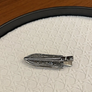 Detail of silver alloy hair clip with micro rhinestones on white textured tray