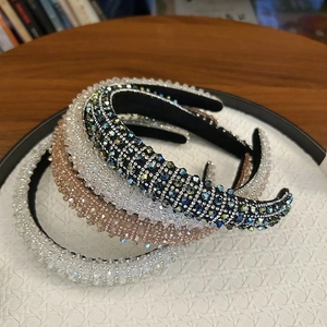 Detail view of multicolored crystal-studded padded headbands in various elegant hues