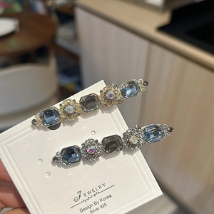 Vintage floral hair clips set with blue and grey rhinestones on gold and silver base
