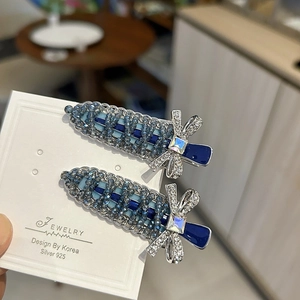 Detail of beaded crystal bow hair clips with silver 925 needles on jewelry card