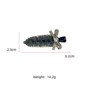 Detailed macro view of blue beaded hair clip with silver rhinestone bow showing dimensions