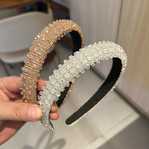 Detail showing hand-held luxury crystal headbands with shiny champagne and silver beads