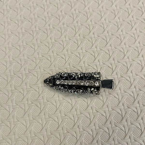 Detailed close-up of handmade beaded hair clip with gray crystals and white rhinestones