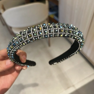 Detailed close-up showing dark AB crystals and white rhinestones on a wide headband