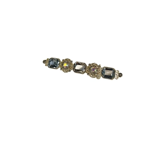 Vintage gold duckbill hair clip featuring blue rectangle gemstones and sparkling rhinestones