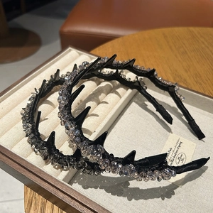 Detail of black crystal headbands with spiked design in a velvet jewelry box