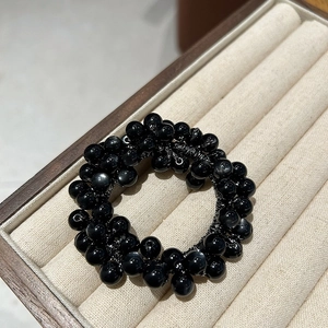 Elegant cat eye stone elastic hair tie with glossy black beads for a stylish look