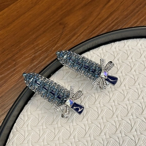 Pair of vintage handmade hair clips with blue crystals and silver bow knot detail