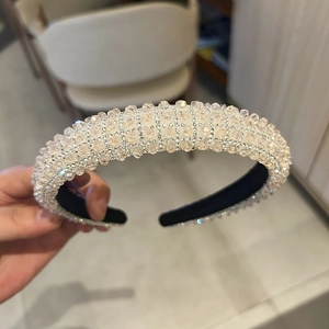 Close-up of champagne crystal beads and sparkling rhinestones on the wide padded headband