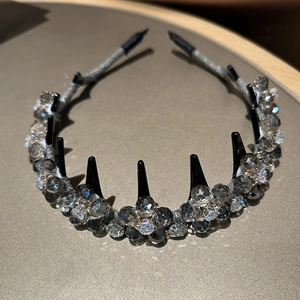 Detail of crystal flower headband with gray faceted beads and black comb teeth