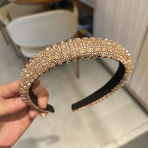 Close-up detail of luxurious champagne gold crystal beads on a padded headband