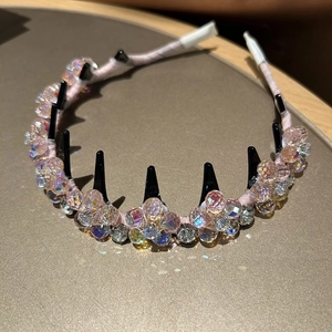 Detailed close-up of pink crystal beads on a headband with non-slip hair teeth